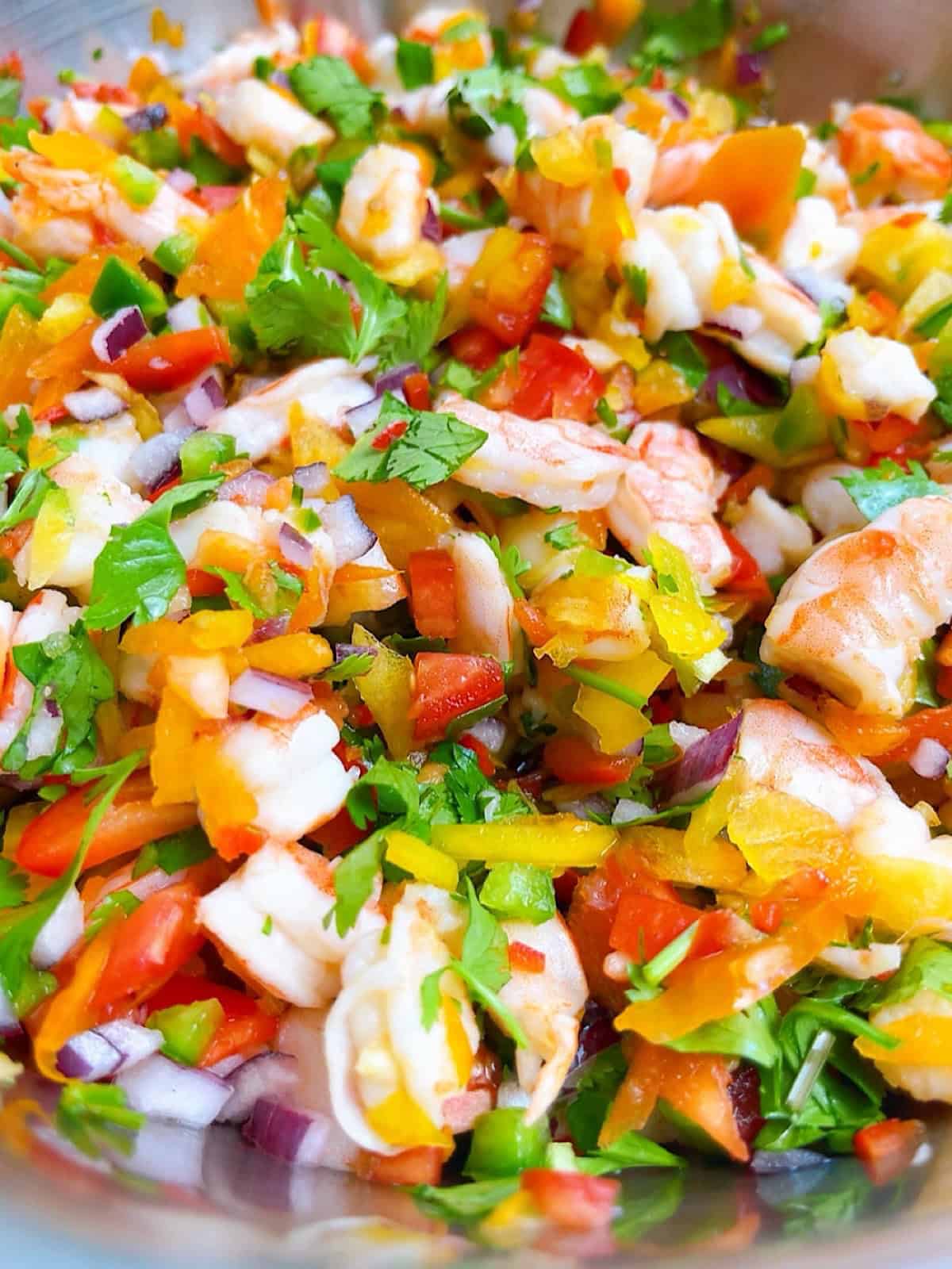 A large bowl of shrimp ceviche with cooked shrimp.