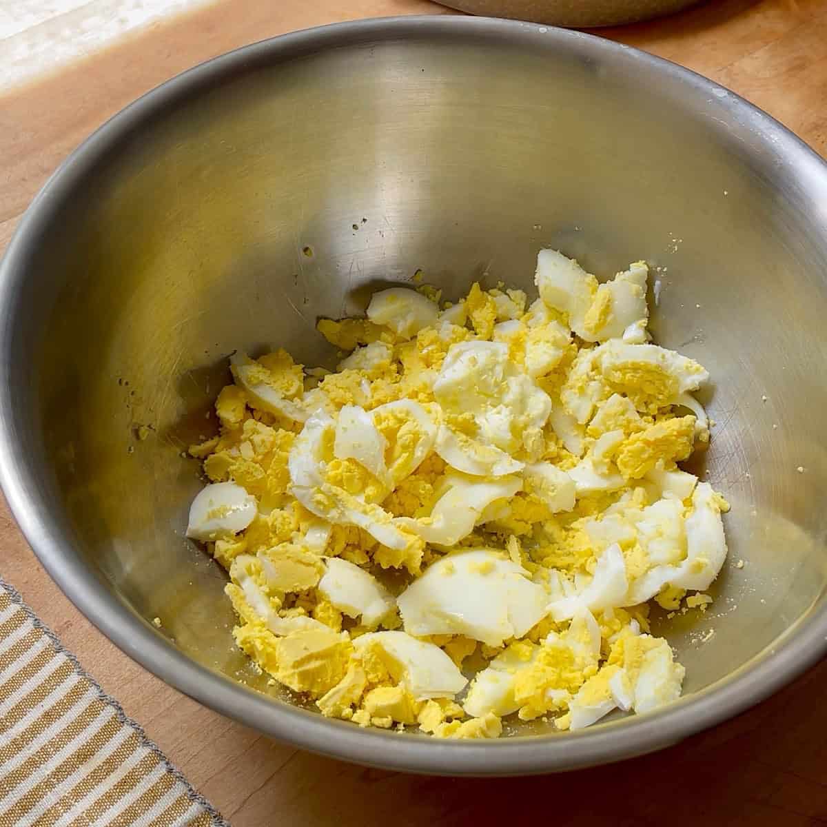Chopped eggs in a large bowl.