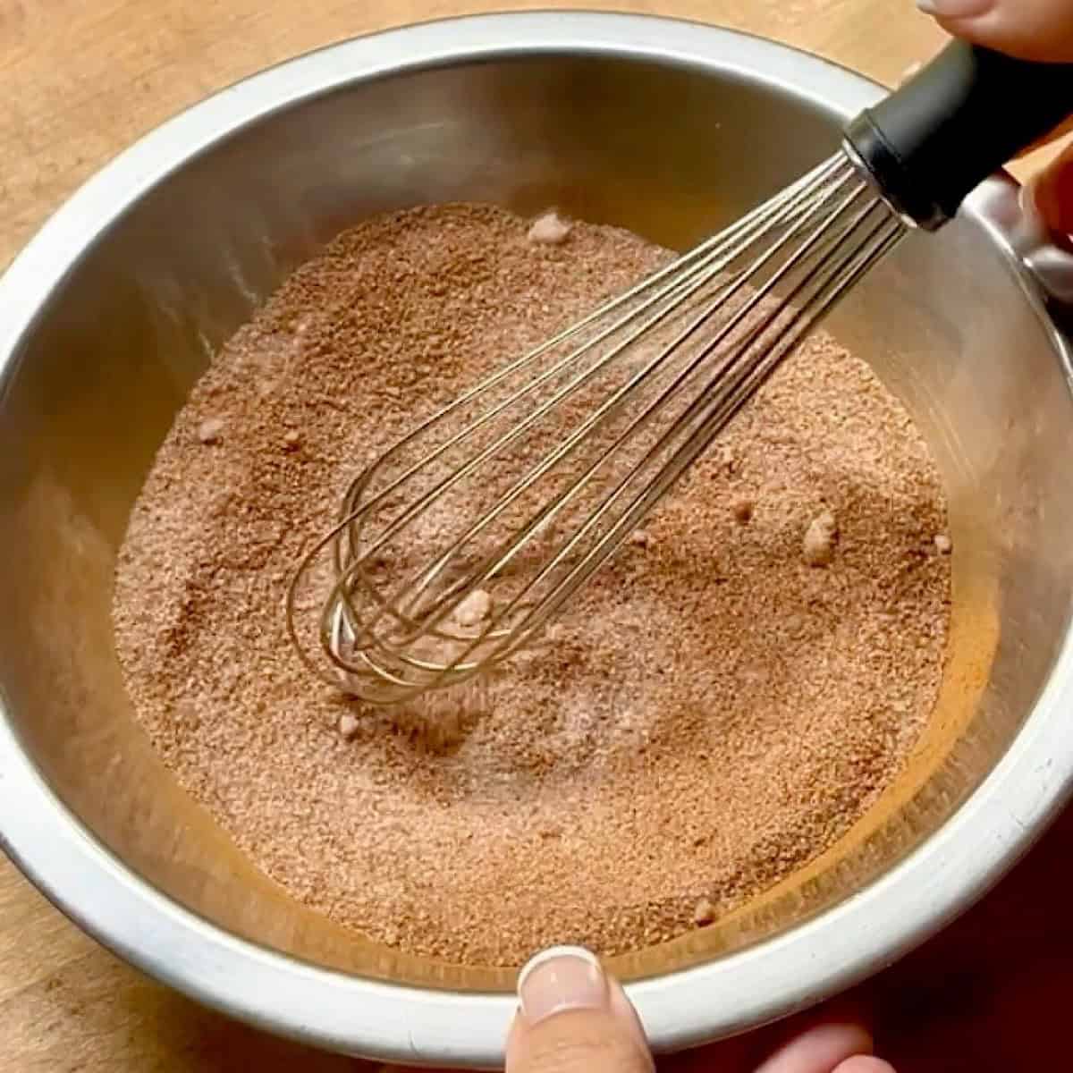 Mixing the cinnamon and sugar together.