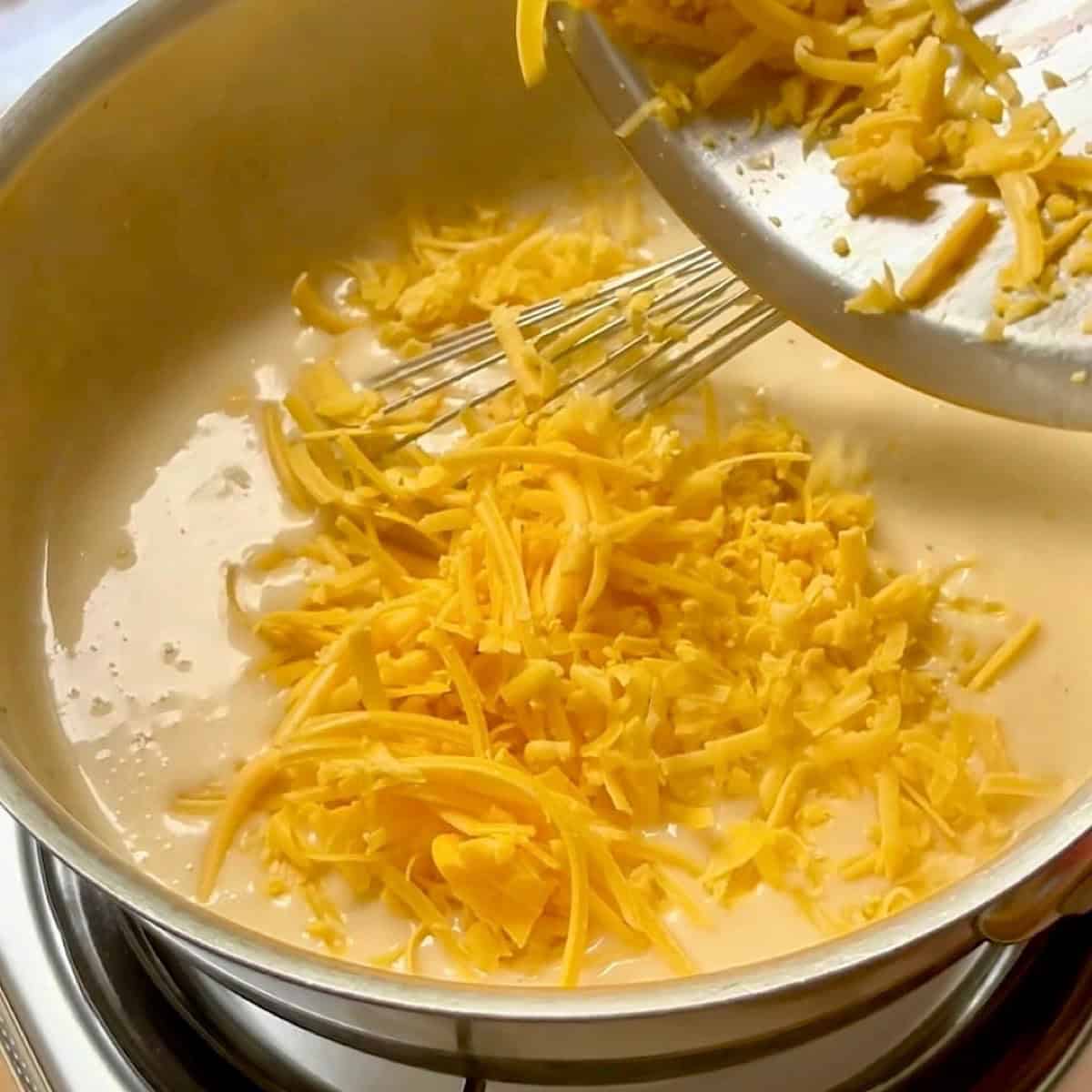 Sprinkling in cheddar to make the broccoli chicken cheese sauce (no soup).