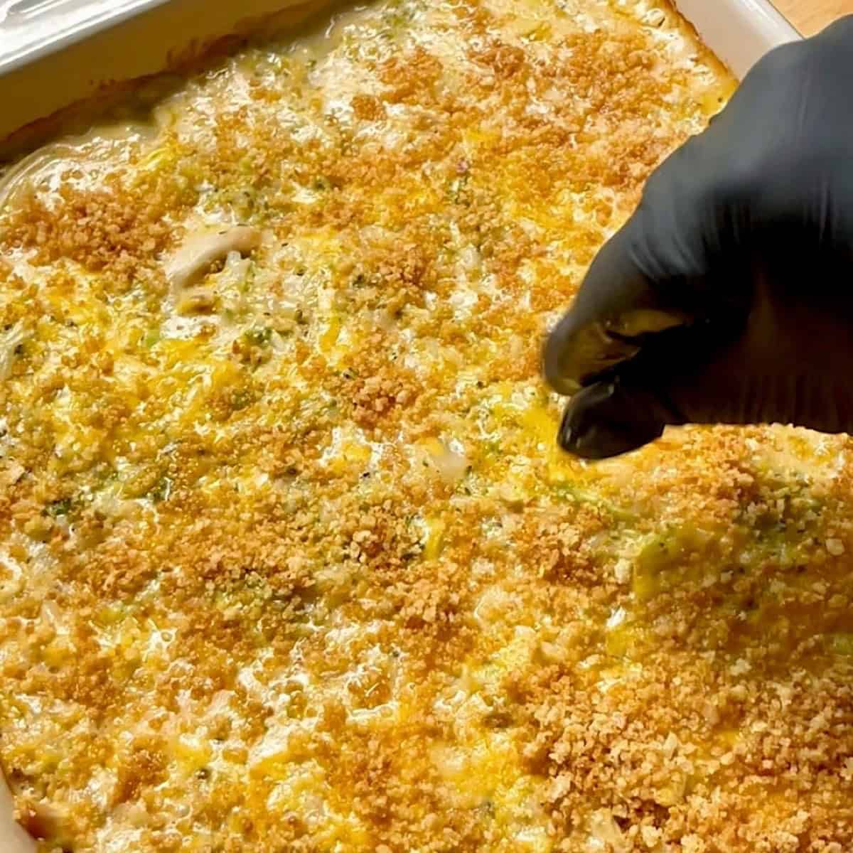 Adding toasted panko to the baked chicken broccoli rice casserole.