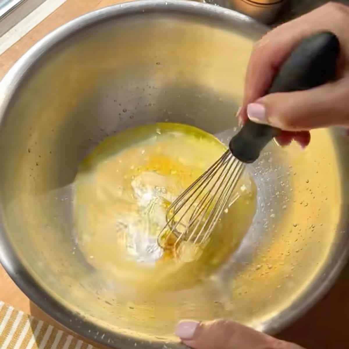 Whisking the mango slaw dressing.