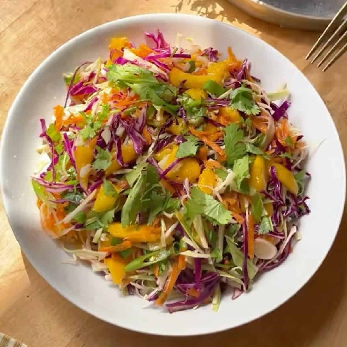 Mango coleslaw in a bowl ready to serve.
