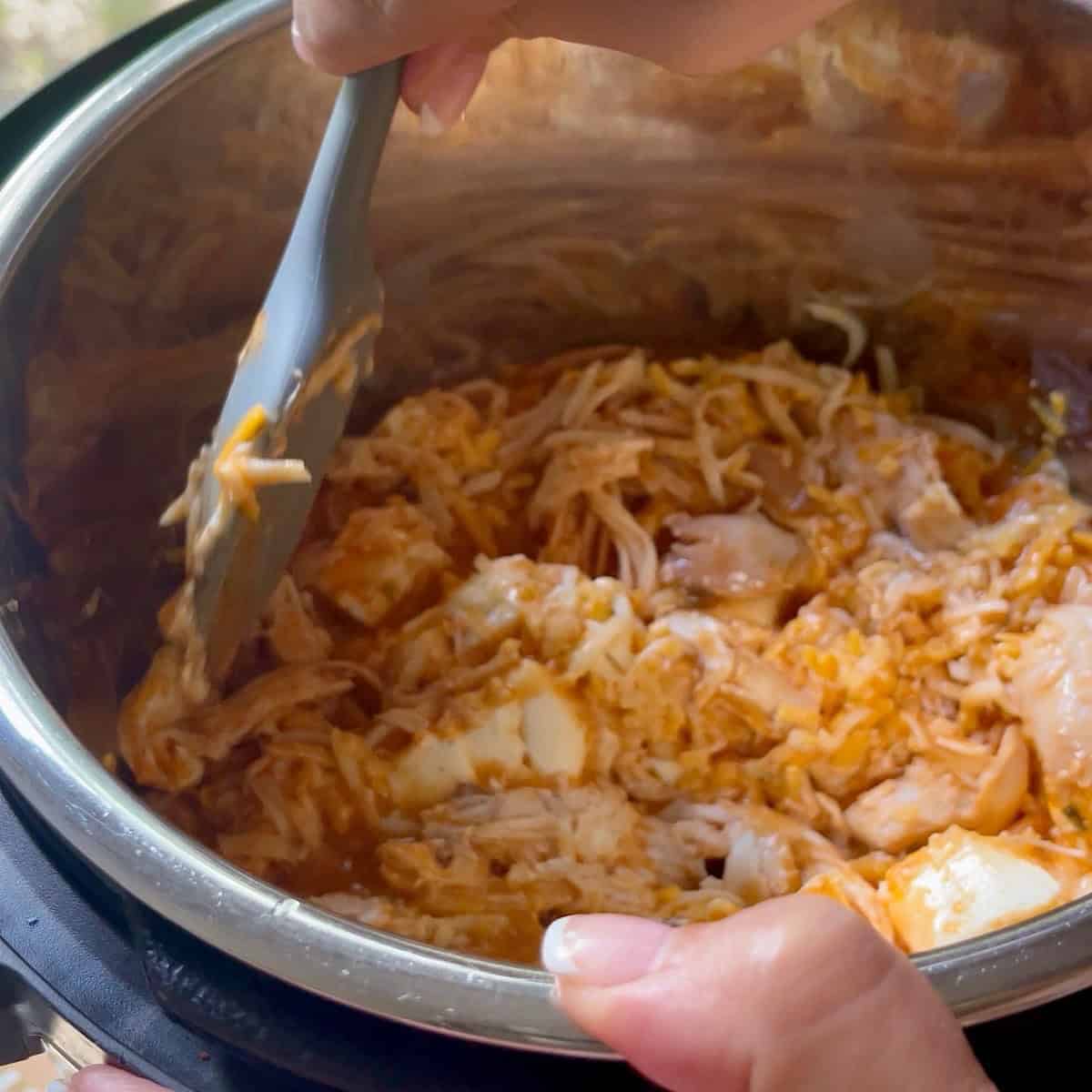 Stirring partially melted ingredients.