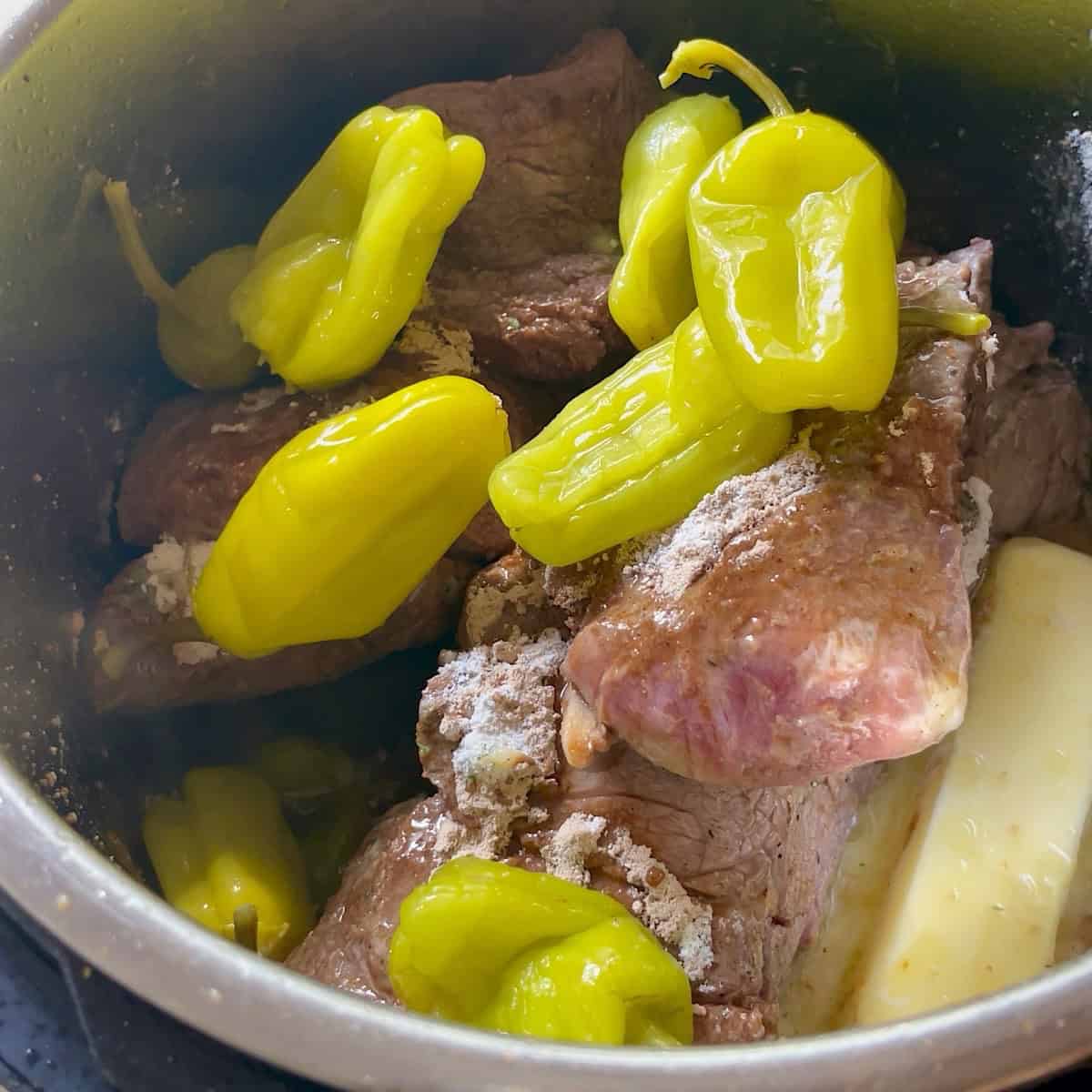 Adding all Mississippi pot roast ingredients to the Instant Pot.