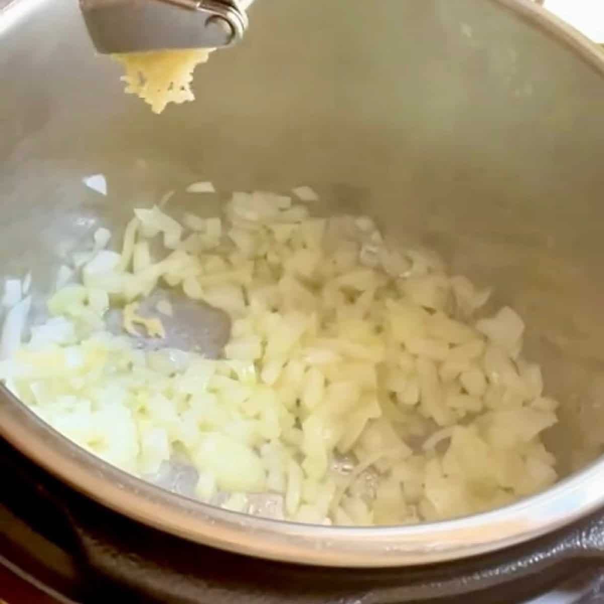Sauteeing garlic with diced onion in the Instant Pot.