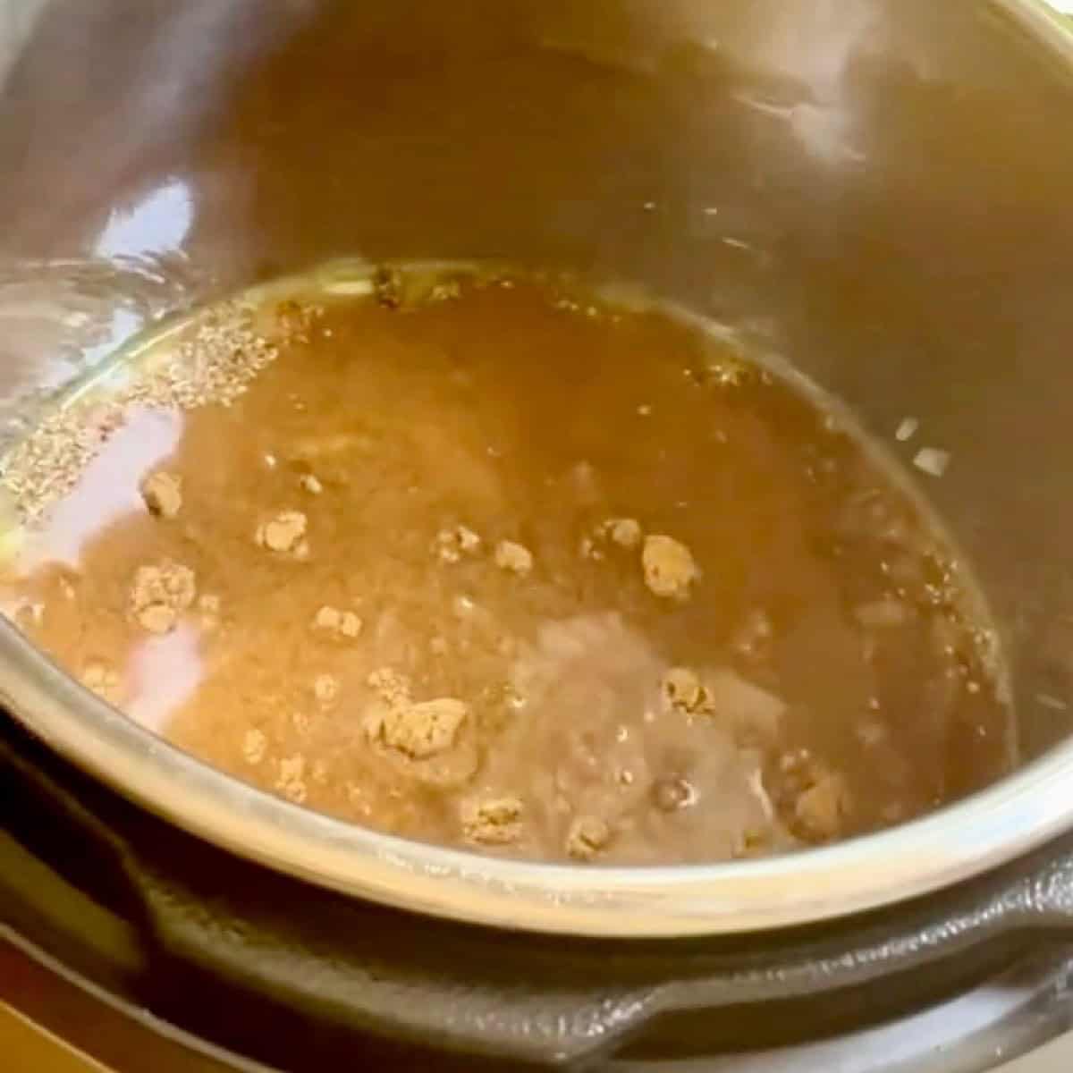 Adding chicken broth and chicken chili seasonings.