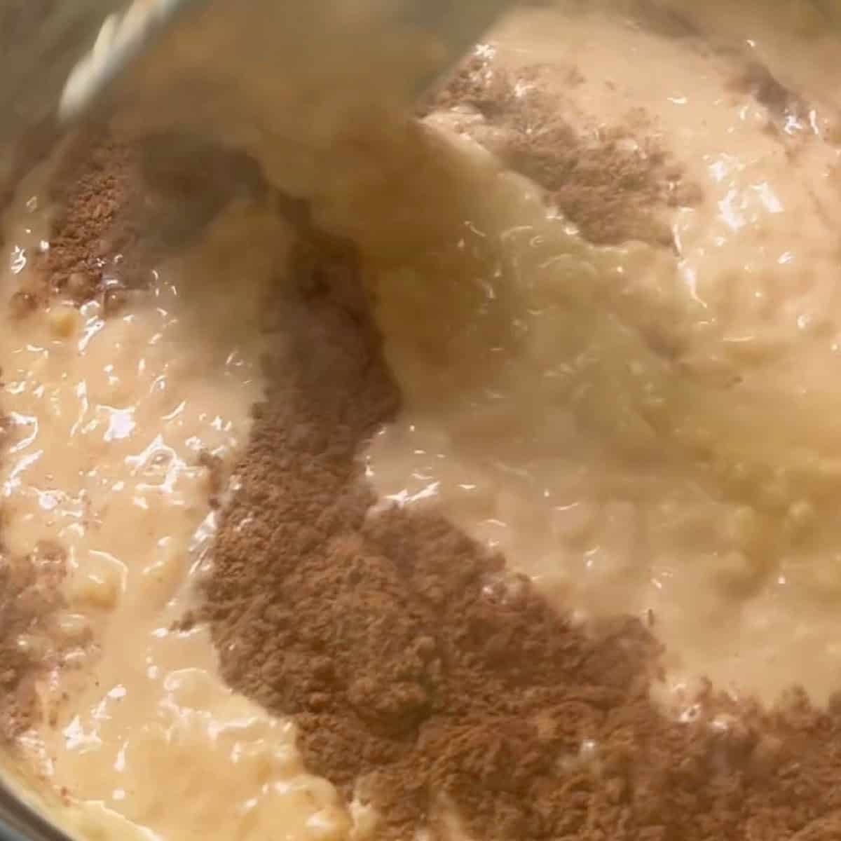 Simmering and adding pumpkin spice, vanilla, and cinnamon.