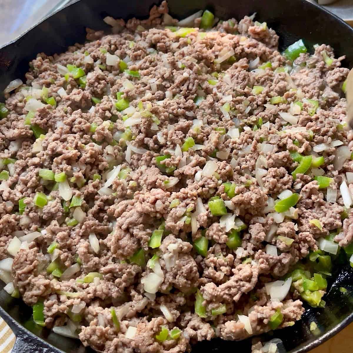 Sauteeing ground beef with vegetables and garlic.
