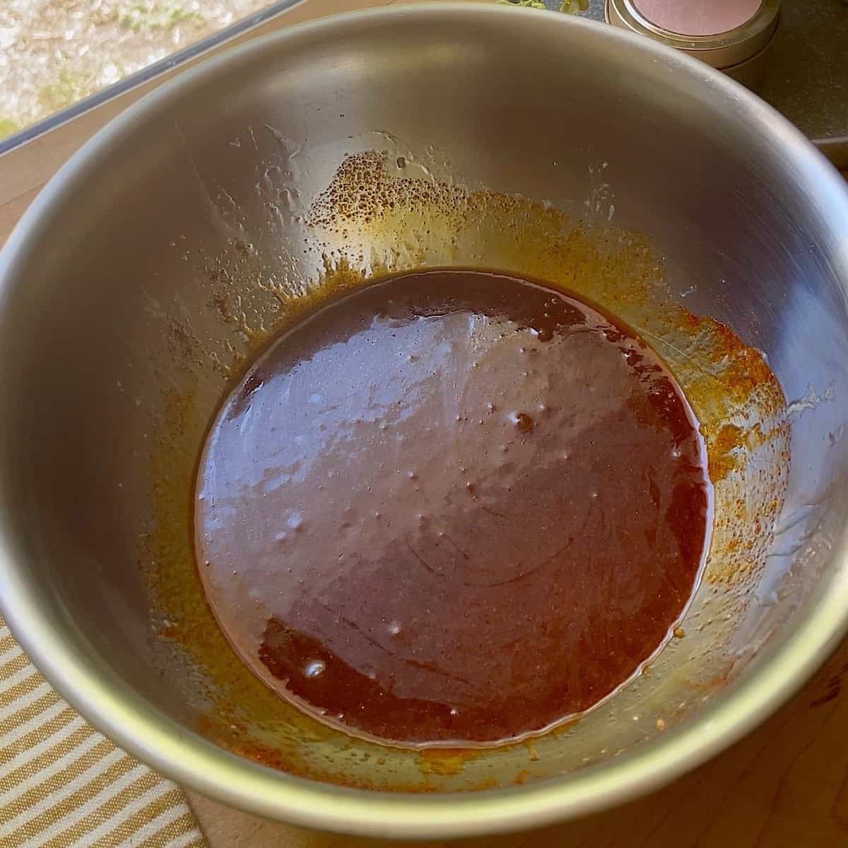 A large mixing bowl with sweet and spicy nut coating.