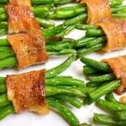 Bacon wrapped green bean bundles on a serving platter.
