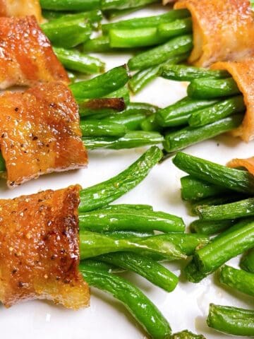 Bacon wrapped green bean bundles on a serving platter.