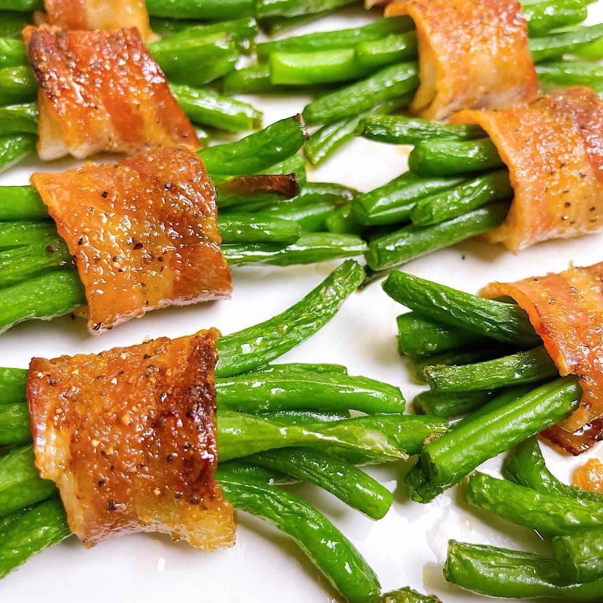 Bacon wrapped green bean bundles on a serving platter.