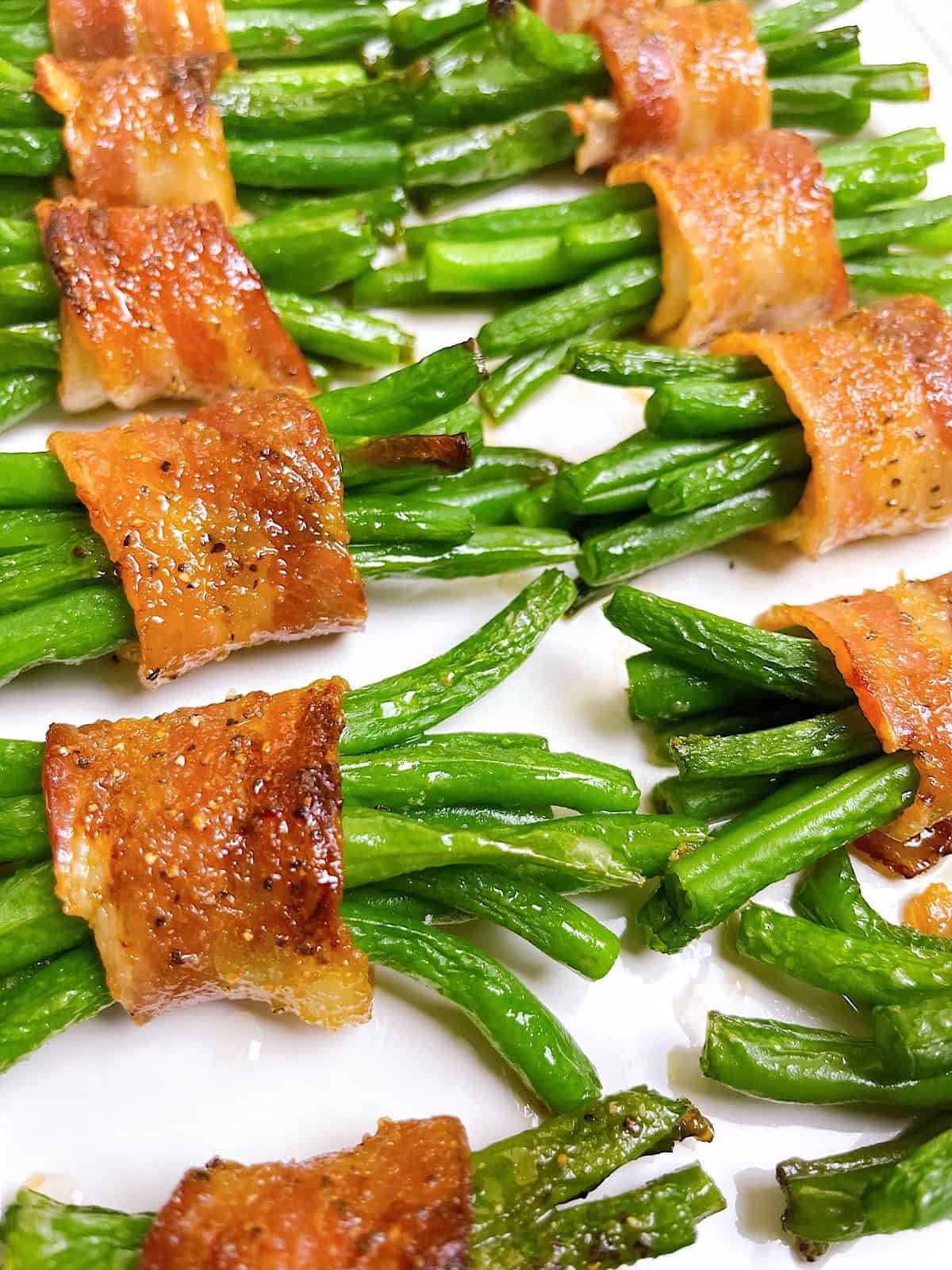 Bacon wrapped green bean bundles on a serving platter.