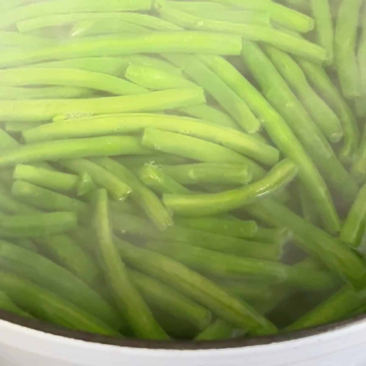 Fresh green beans in boiling water.