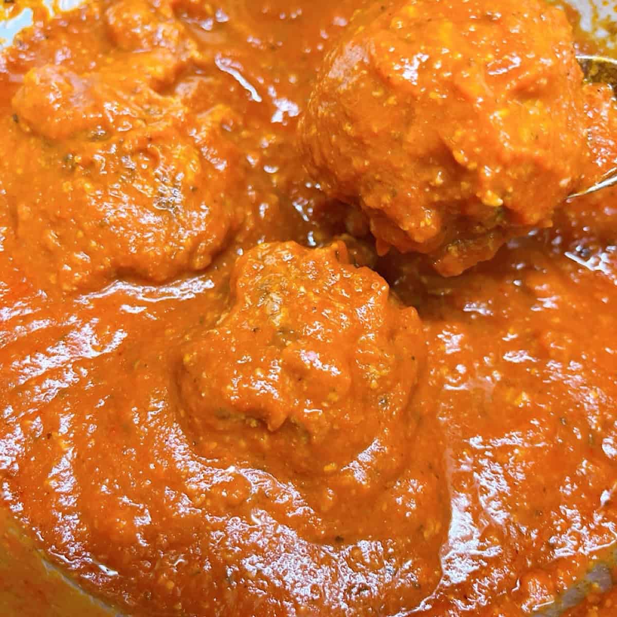 Warming the meatballs in spaghetti sauce.