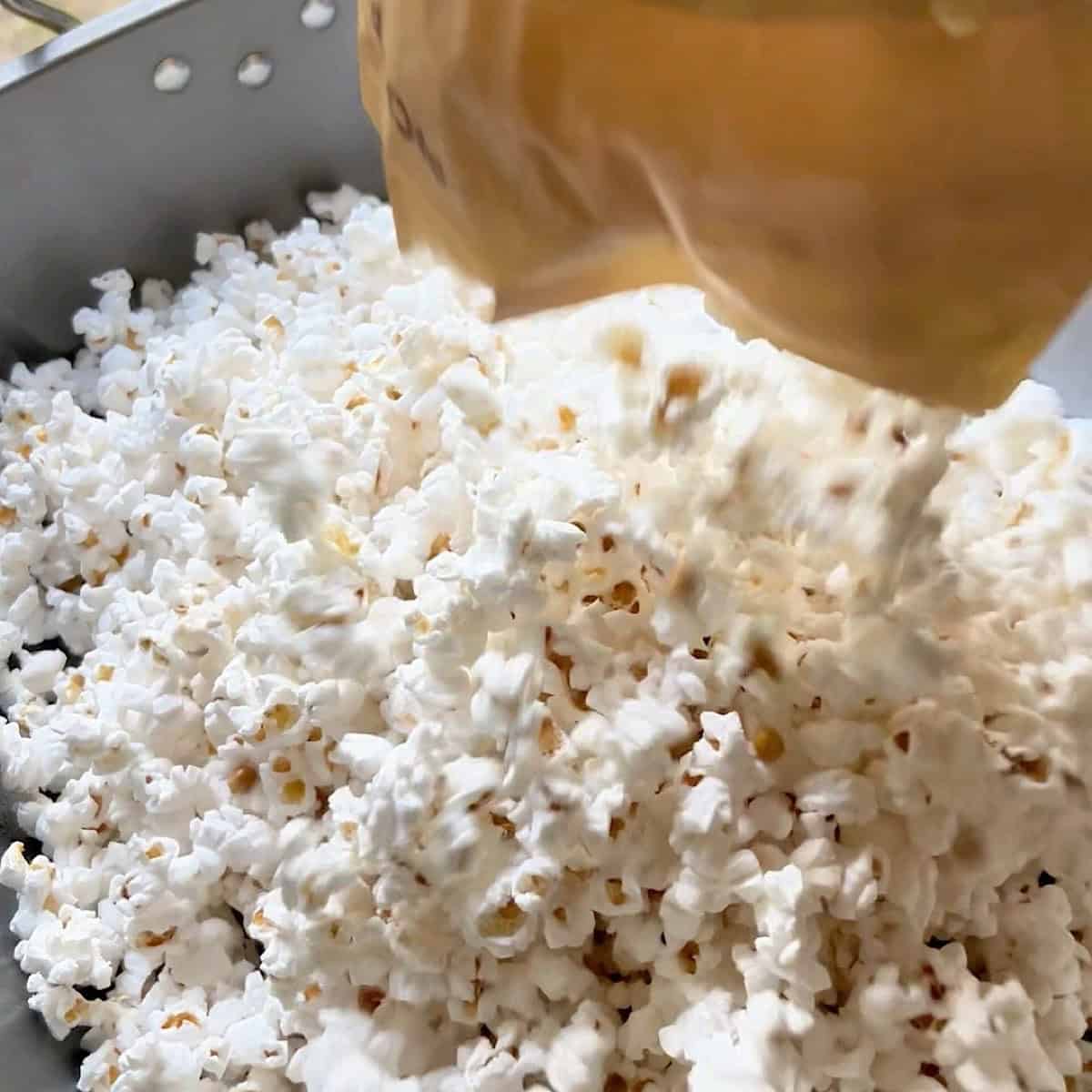 Adding microwave popcorn to the roasting pan.
