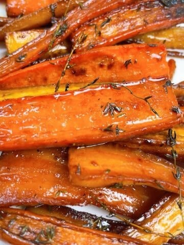 Carrots and parsnips with honey butter glaze on a platter.