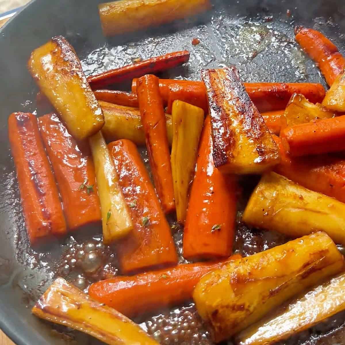 Carrots and parsnips flipped to show charred edges.