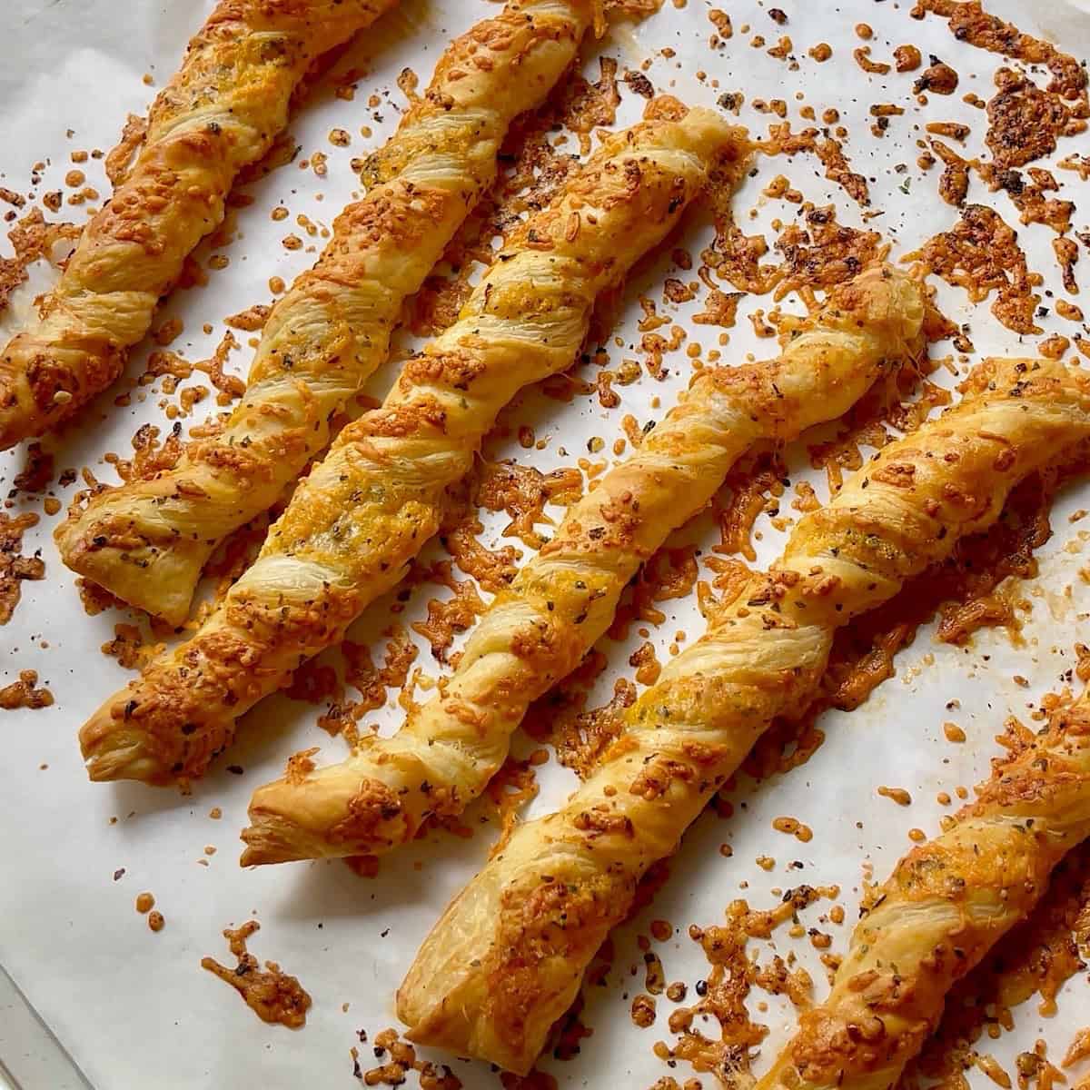 Cheese twists removed from the oven and still on sheet pan.