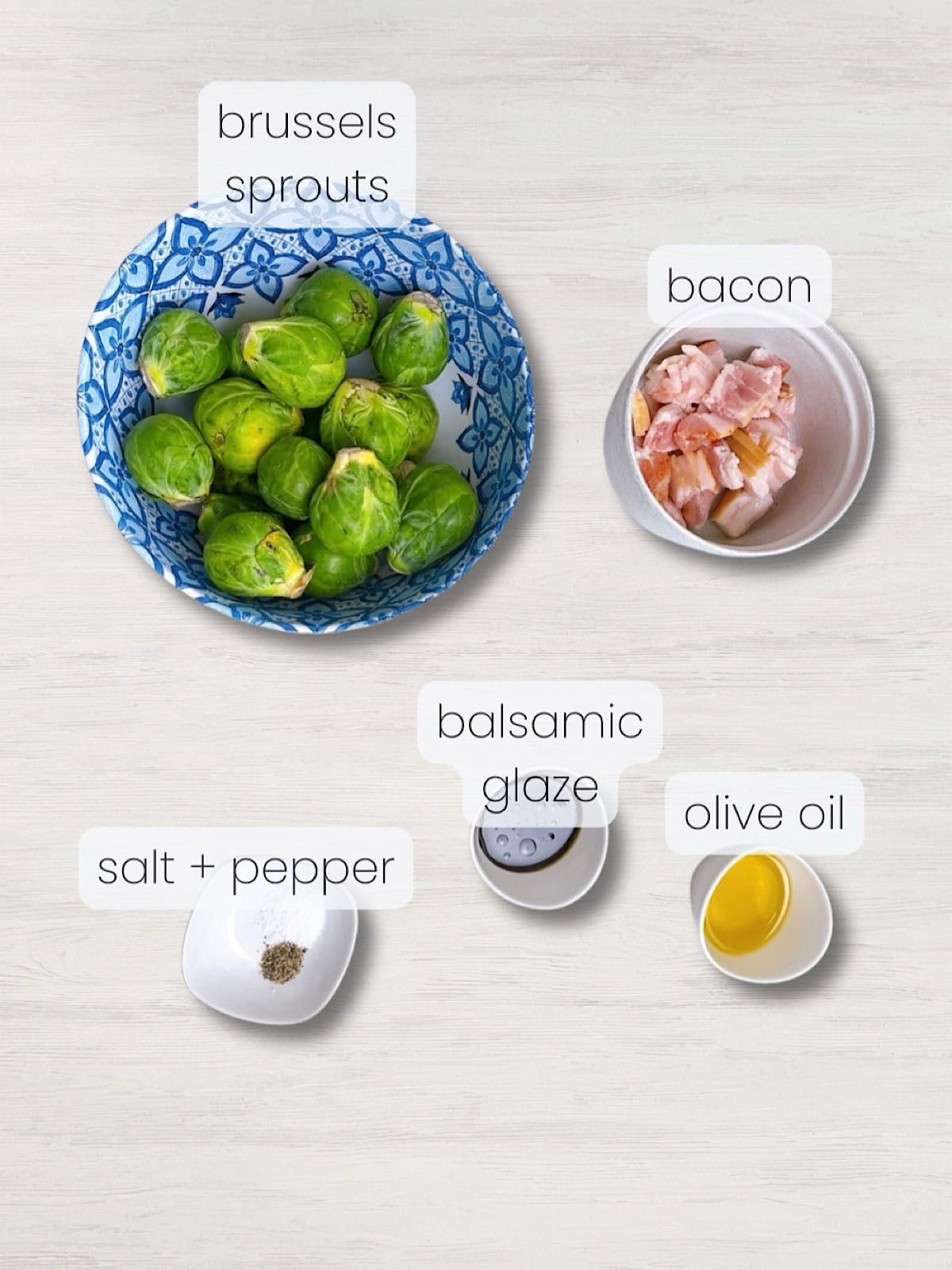 A labeled image of everything needed to make crispy brussels with bacon.