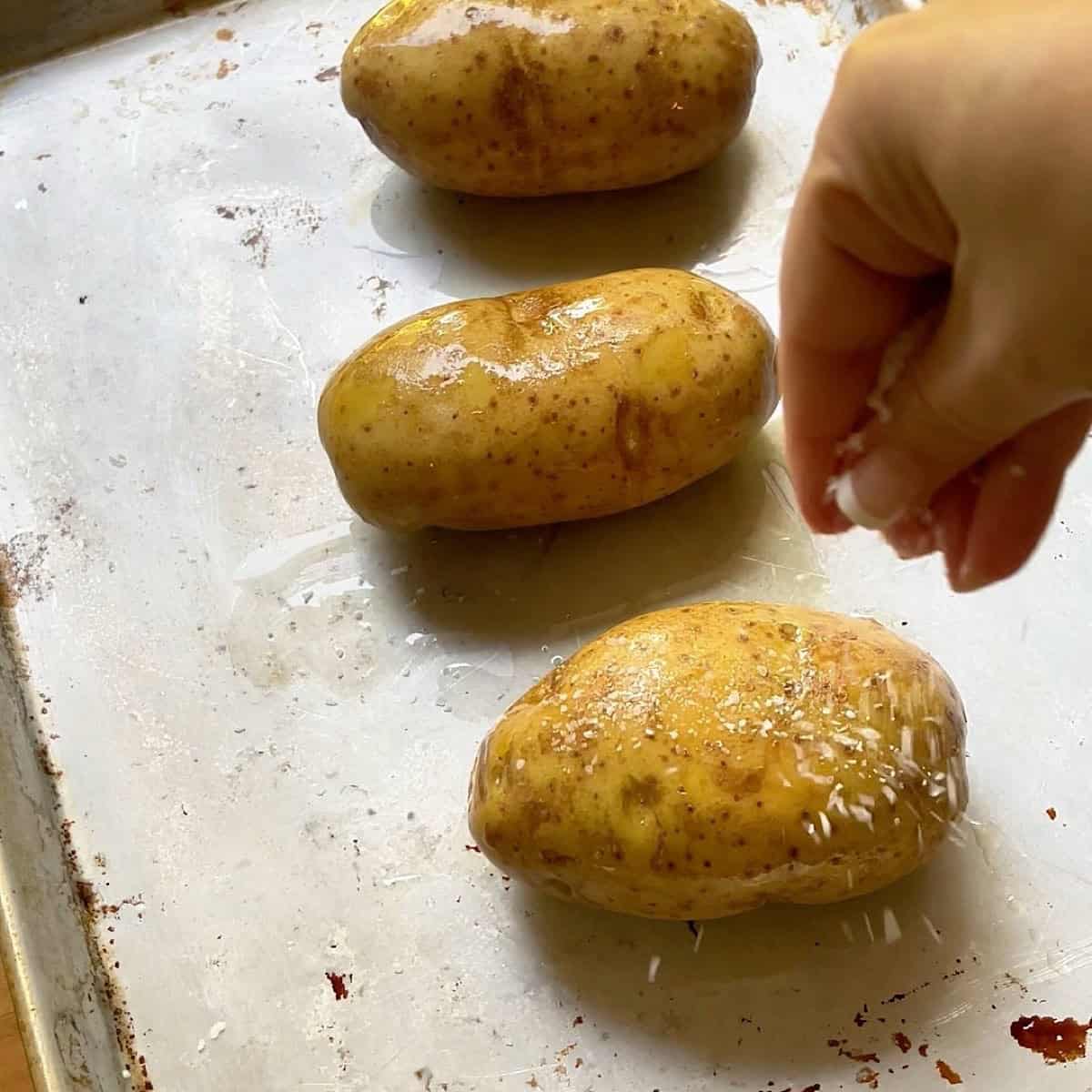 Baked potatoes rubbed with oil and salted.