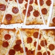 Lavash pizza with pepperoni cut into diagonal wedges.