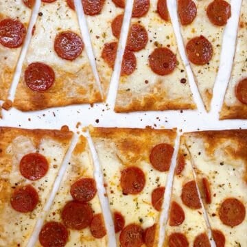 Lavash pizza with pepperoni cut into diagonal wedges.