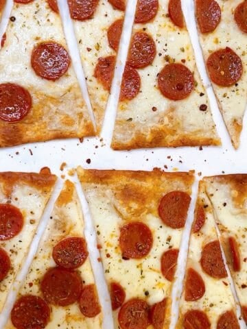 Lavash pizza with pepperoni cut into diagonal wedges.