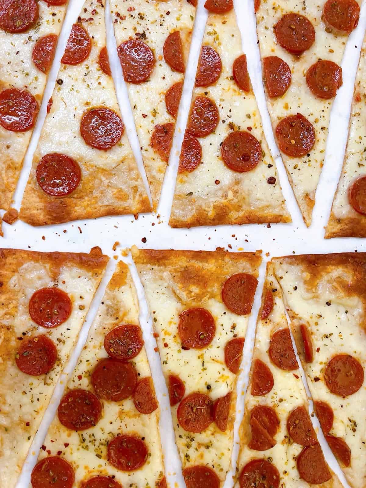 Lavash pizza with pepperoni cut into diagonal wedges.