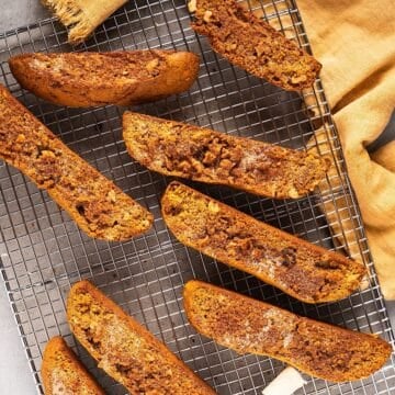 Pumpkin spice biscotti on a wire rack with autumn linen.