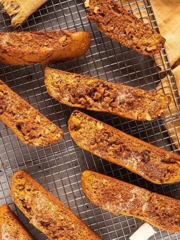 Pumpkin spice biscotti on a wire rack with autumn linen.