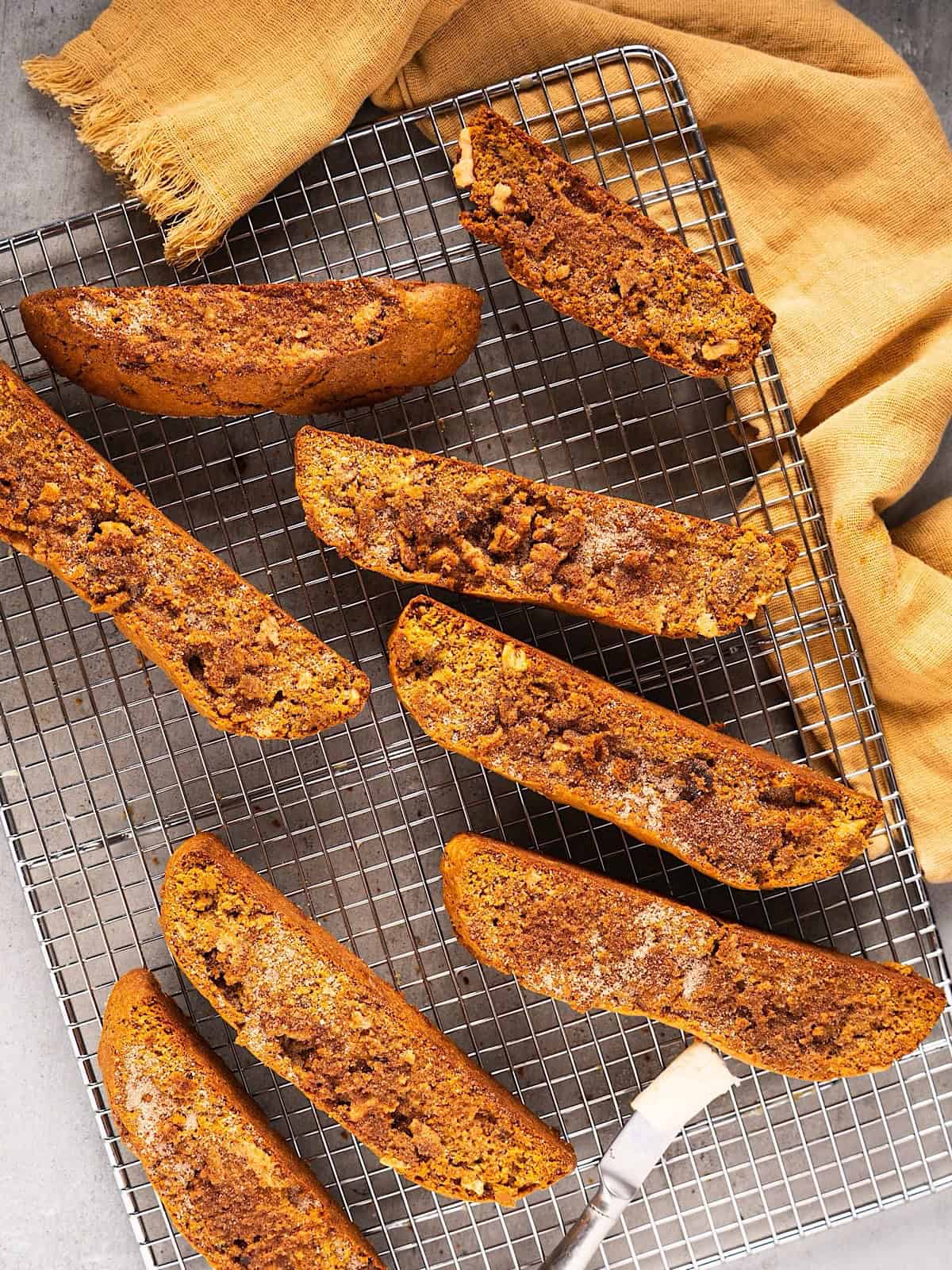 Pumpkin spice biscotti on a wire rack with autumn linen.