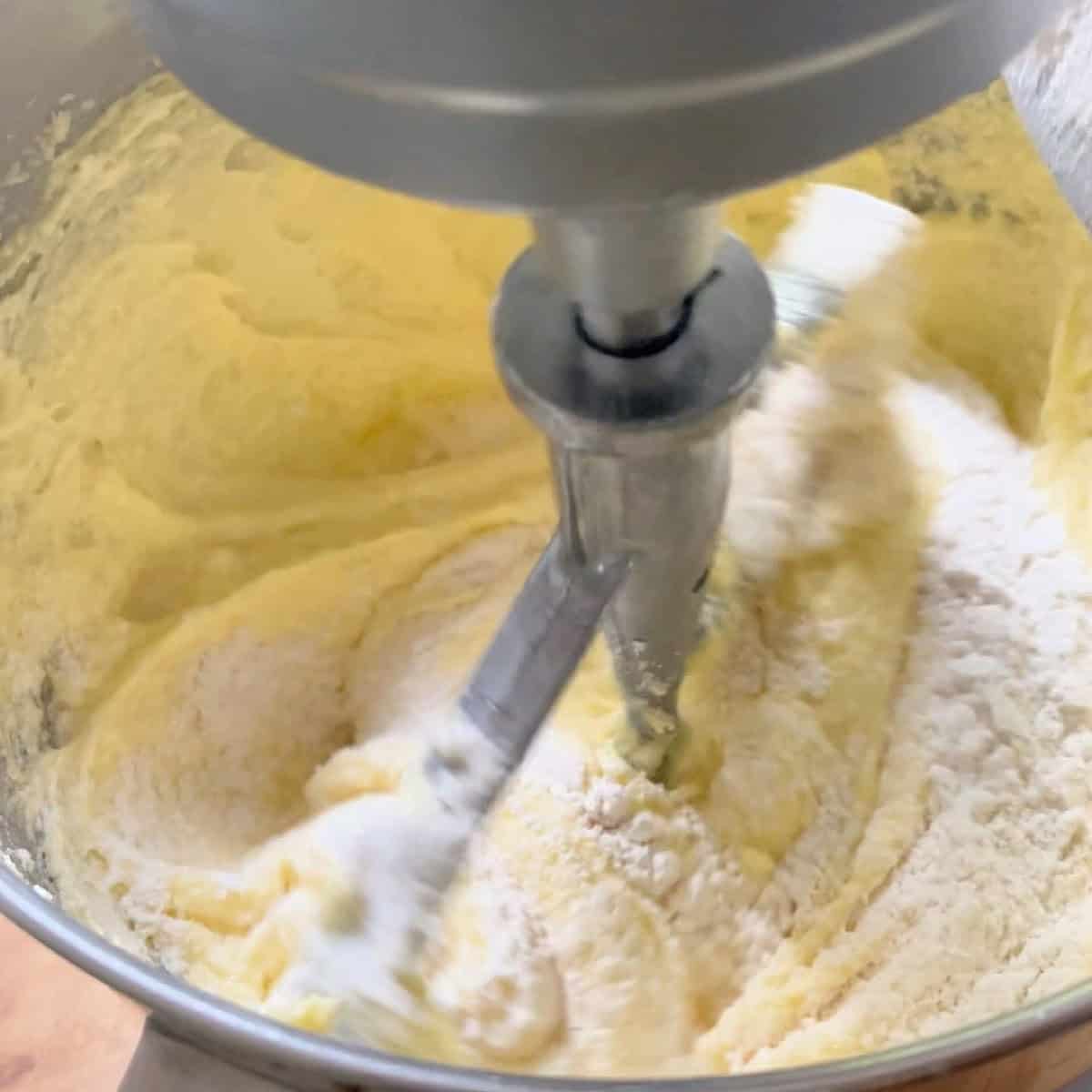 Adding flour and cream to batter.