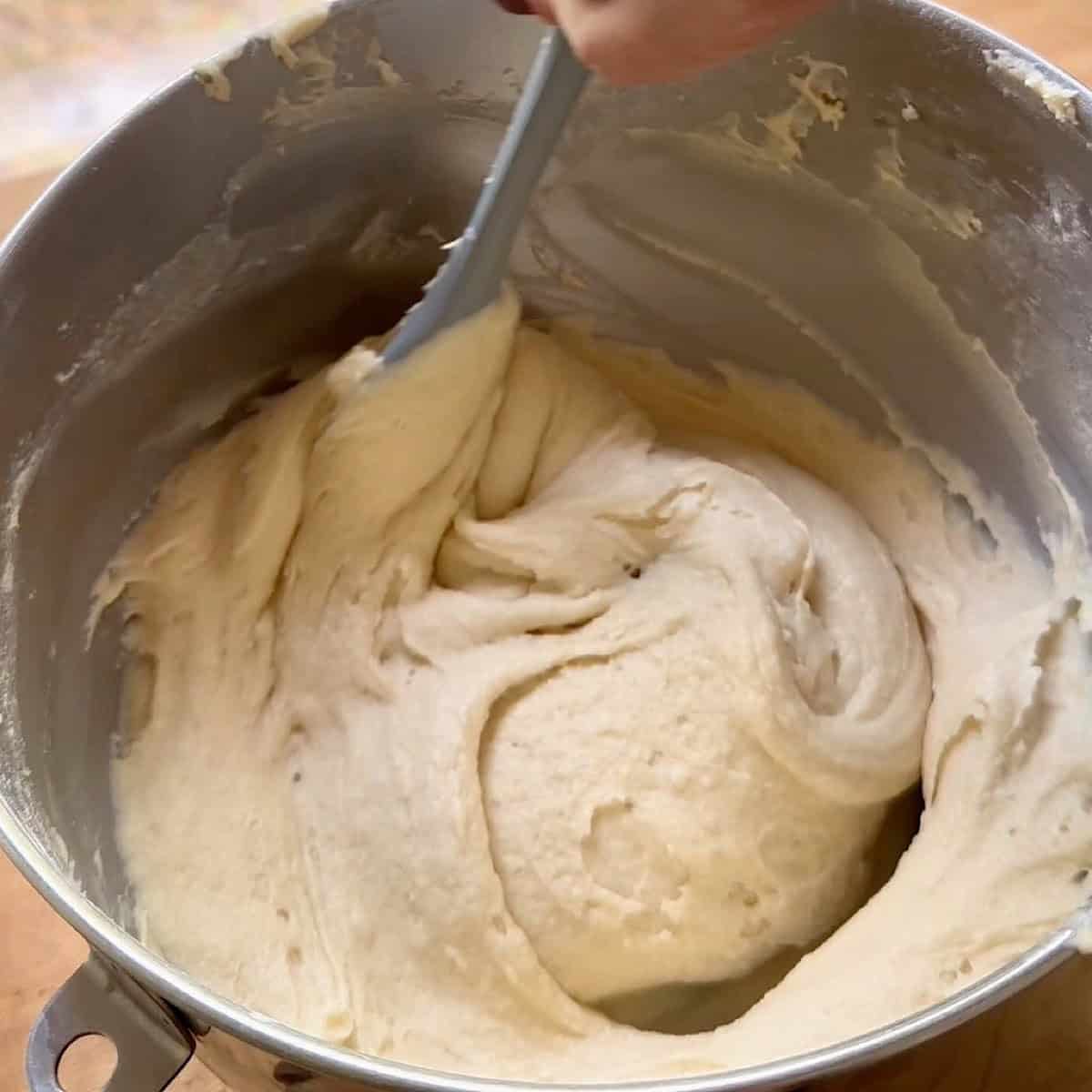 Combining wet and dry ingredients in a mixing bowl.