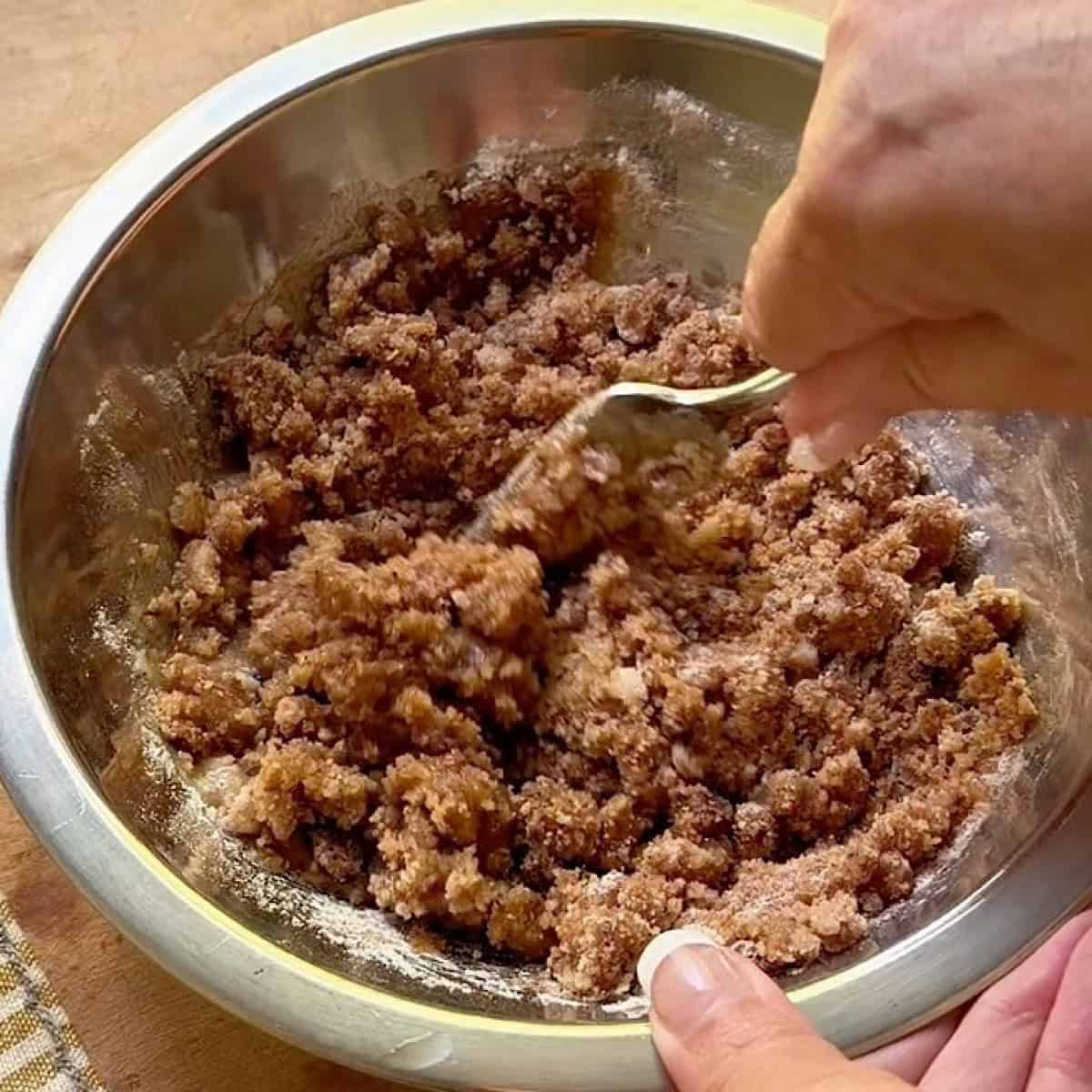 Mixing the streusel topping with a fork.