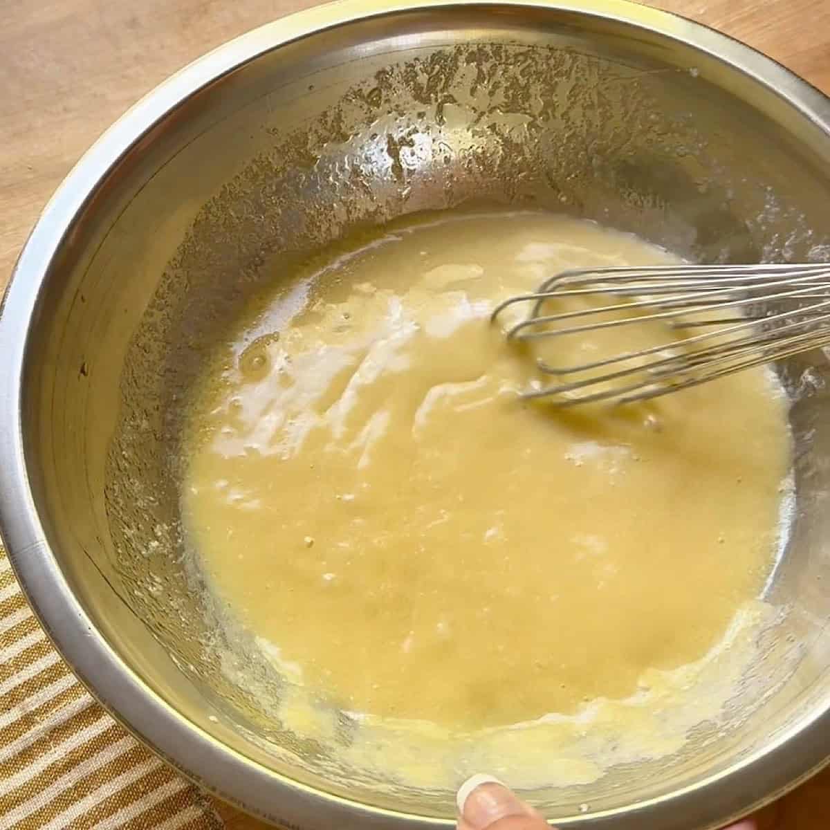 Whisking the wet ingredients for jumbo muffin batter.