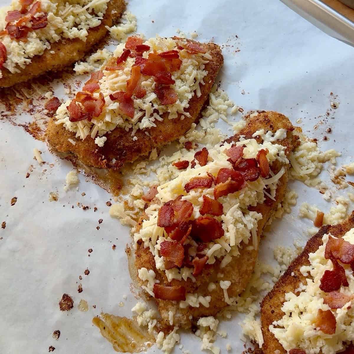 Cheese and bacon topping added to the crispy chicken for final bake.