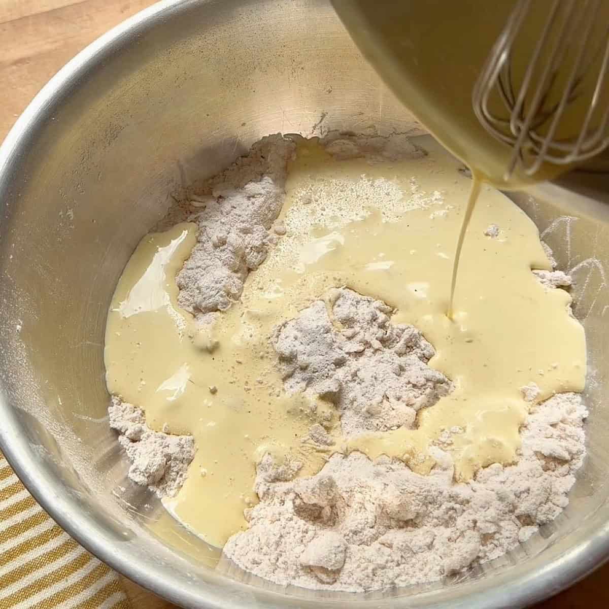 Combining the wet and dry ingredients.