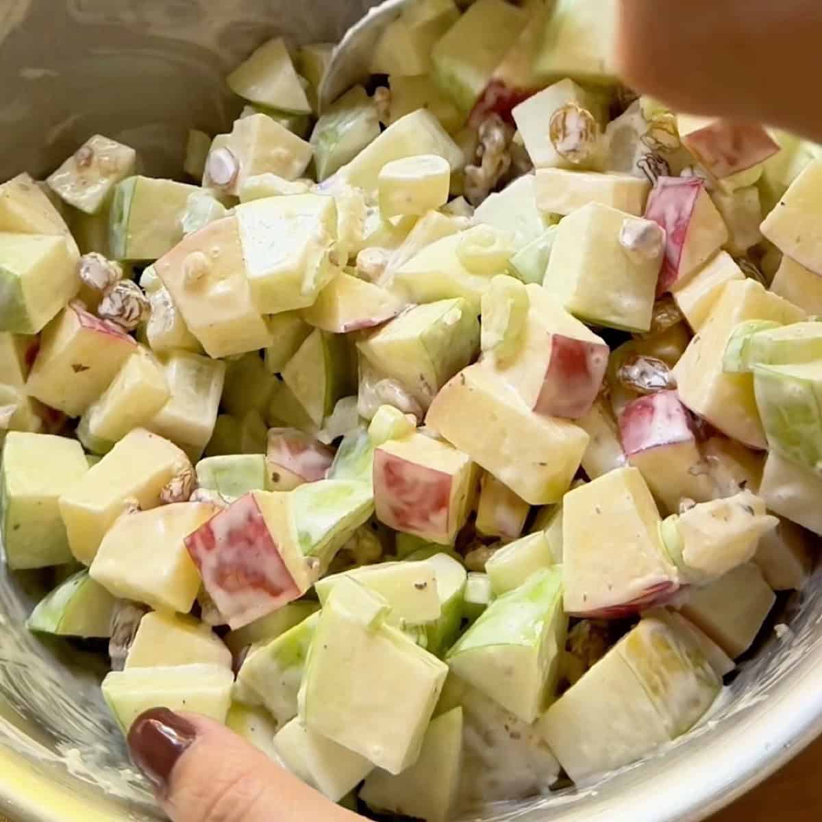 Combined fruits and nuts folded into the dressing.