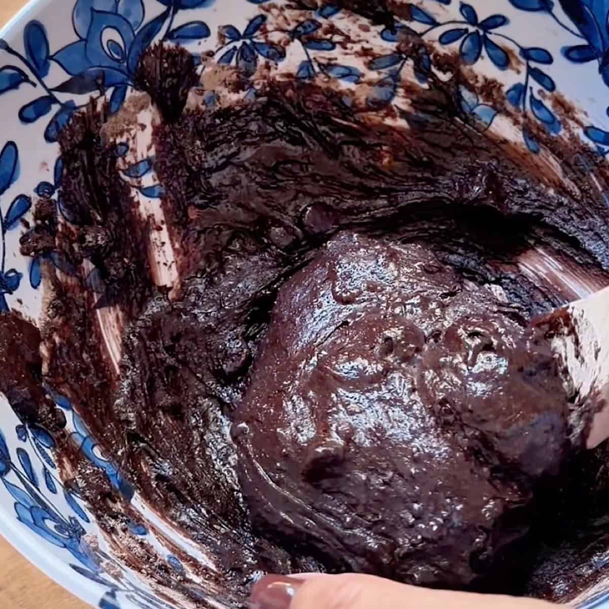 Mixing brownie batter in a large mixing bowl.