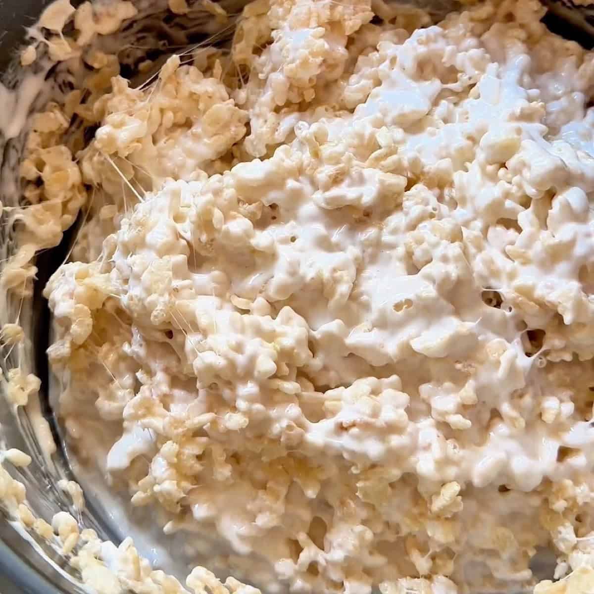 Folding Rice Krispies cereal into the marshmallow base.