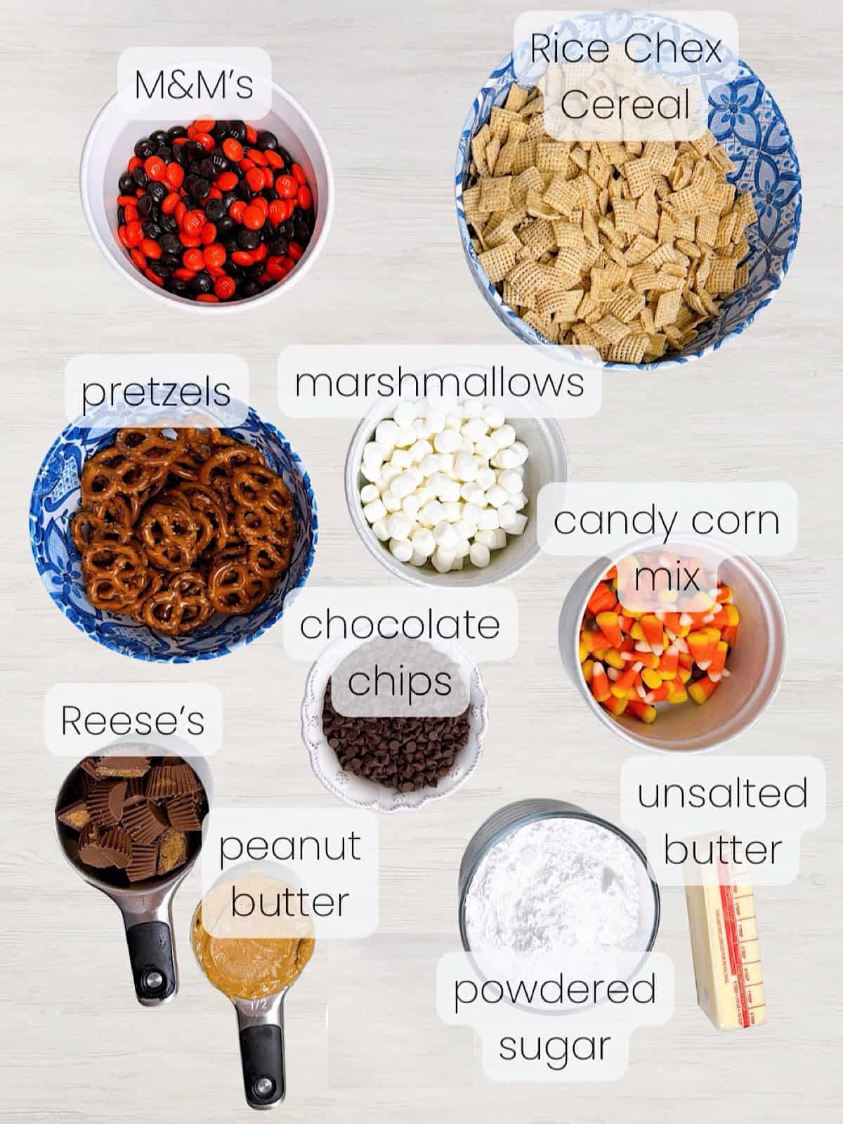 A labeled image of everything needed to make Halloween Snack Mix with Muddy Buddies Puppy Chow