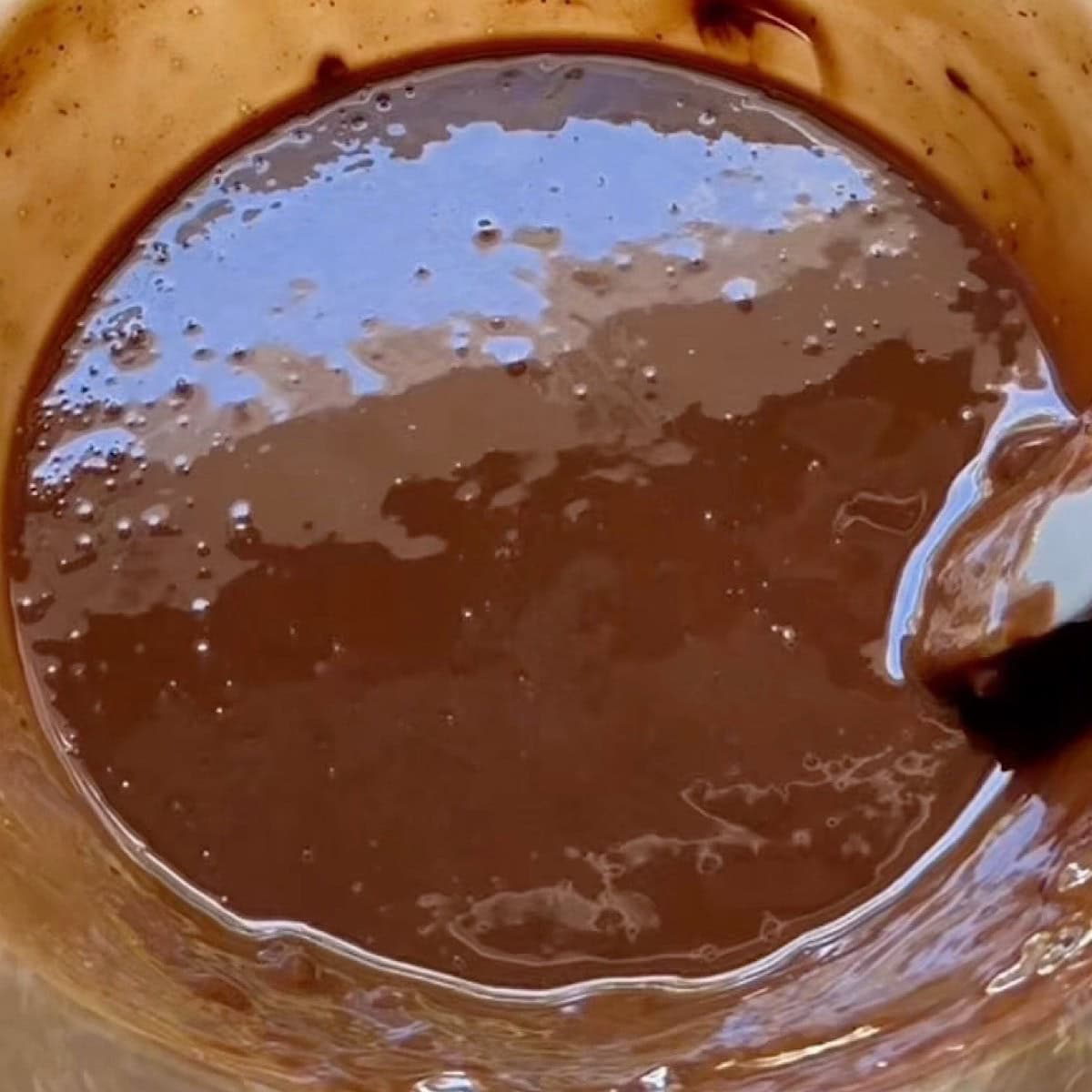 Chocolate peanut butter mixture melted in a microwave safe bowl.