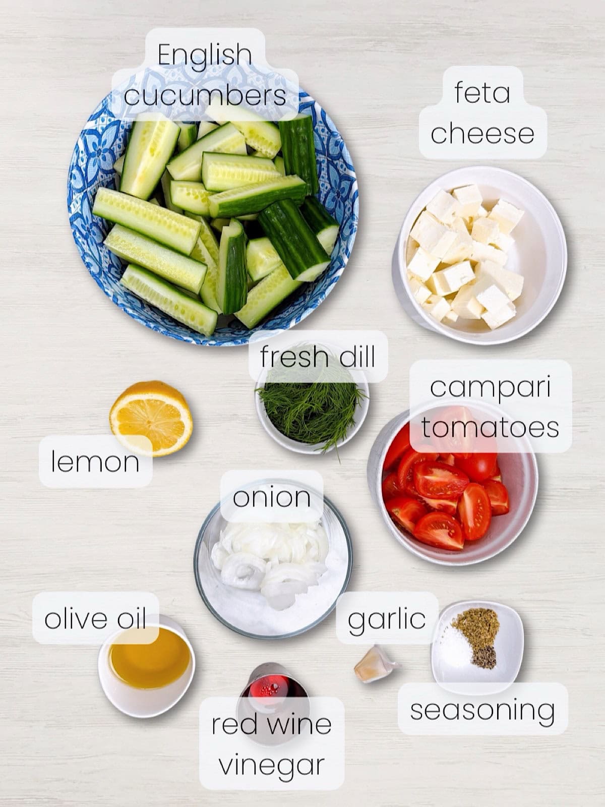 A labeled image of everything needed to make this Mediterranean Cucumber and Tomato Salad with Feta.