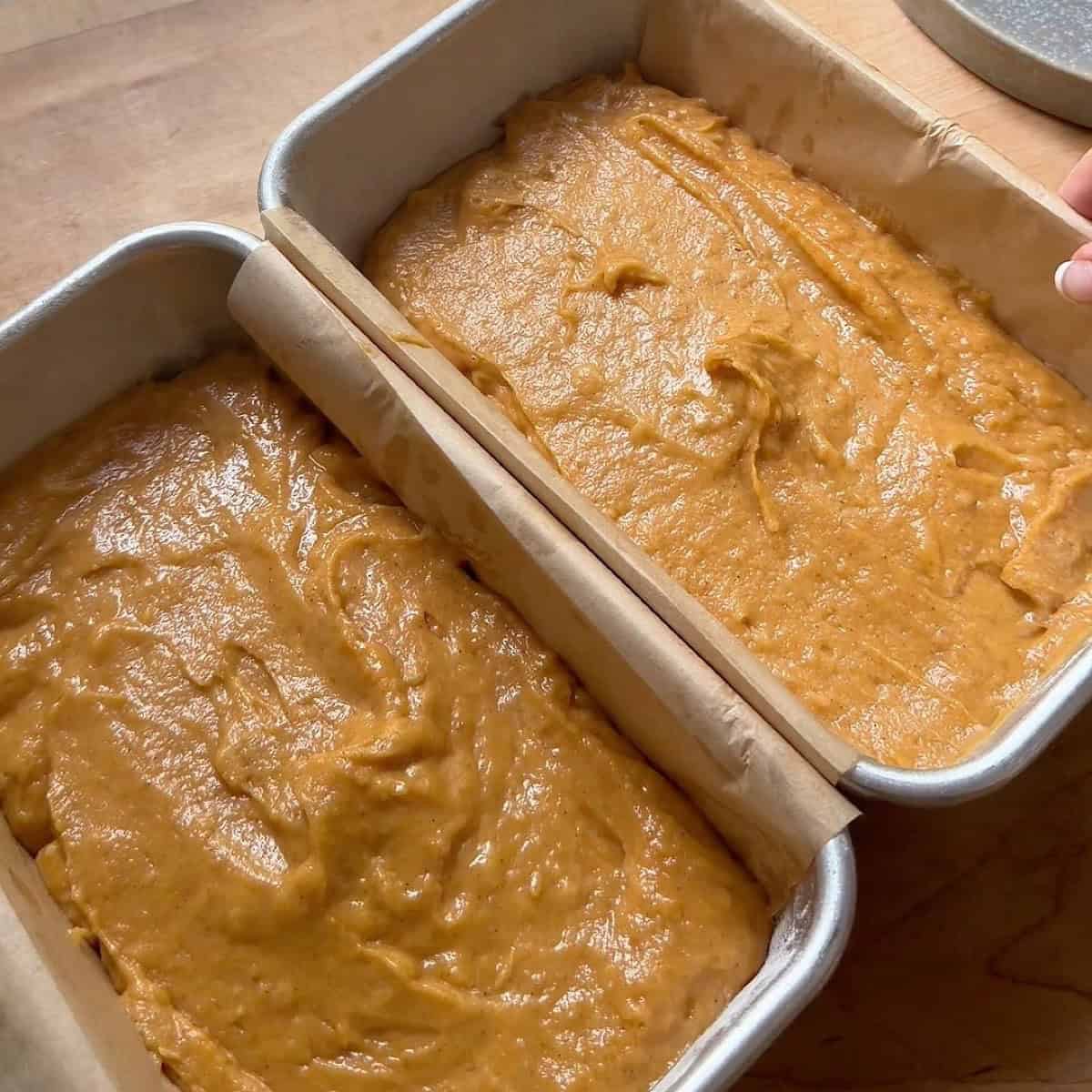 Batter evenly divided between two parchment lined loaf pans.