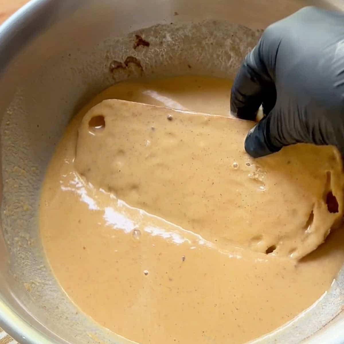 Soaking the sourdough bread in custard.