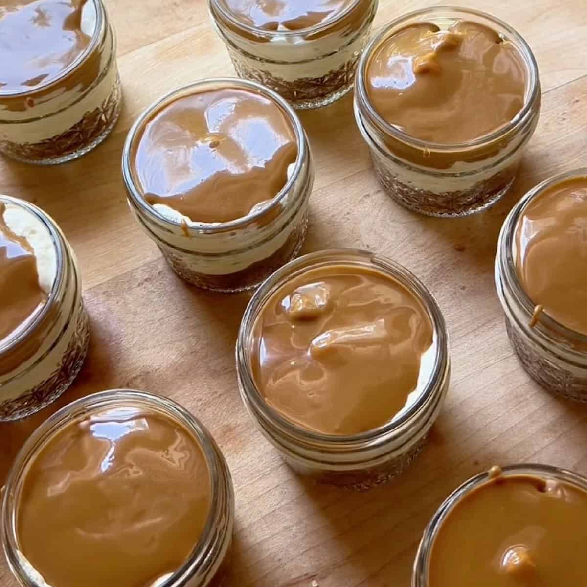 Biscoff cheesecake jars topped with Biscoff cookie butter.