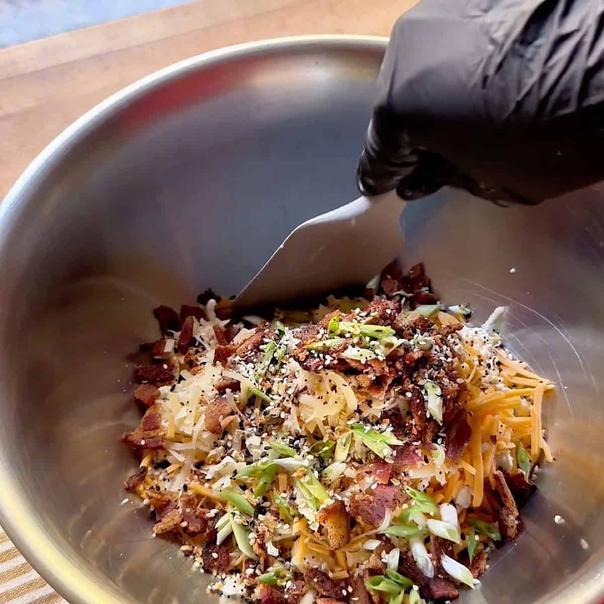 Mixing blue cheese ball ingredients in a mixing bowl.