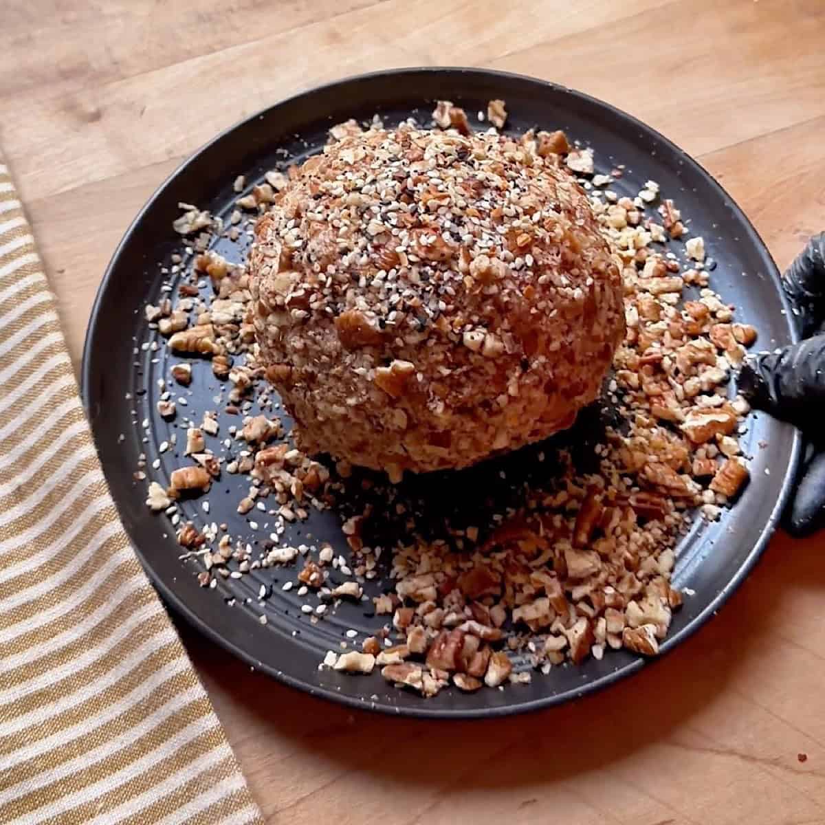 Chilled blue cheese ball rolled in pecan coating.